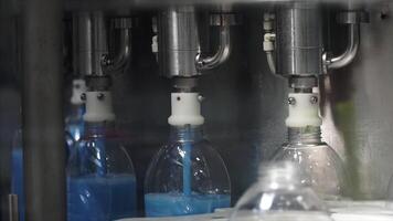 Liquid detergent on automated production line. Clip. Machinery for bottling video