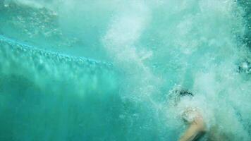 Man jumping into swimming pool. Scene. Underwater video shooting. Swimmer jumps into the water in the pool