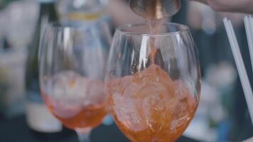 A close up of orange cocktails, glasses and ice. Frame. Perfect summer drinks video