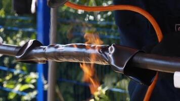 Close-up of flame heating the pipe. Frame. Outdoor craft video