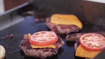 rendere hamburger su il griglia ristorante. clip. hamburger cucinando su un' gas griglia nel il sera sole video