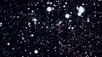 Many round colorful particles in space moving in a circle on black background, seamless loop. Animation. Small chaotic dots of red, yellow, blue colors flying in the dark. video