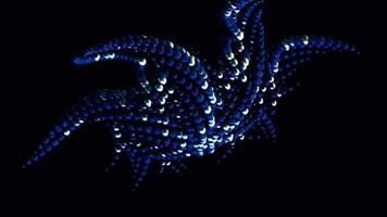 Abstract colorful star fish shaped figure formed by small gathered spheres moving on black background, seamless loop. Animation. Blue circles moving fast. video