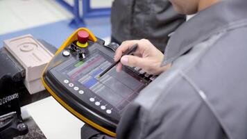 Worker uses touch control panel. Scene. Skilled worker uses electronic control panel in modern enterprise. Close-up of worker setting tasks on electronic control panel video