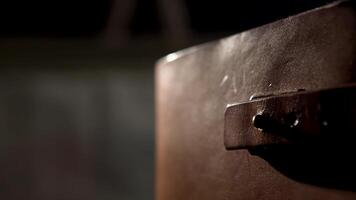 Old leather book with a strap. Stock footage. Close up of an ancient leather brown diary or book with yellow pages isolated on black background. video