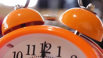 Close up of retro alarm clock going off on blurred background. Stock fooatge. Orange alarm clock details for waking up in the morning. video