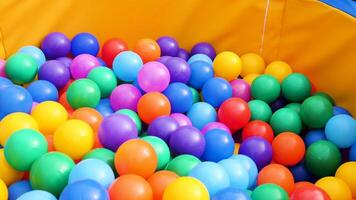 Colorful plastic balls in a pool for for children. Stock footage. Close up of lots of colored balls in a playground ball pool, having fun concept. video