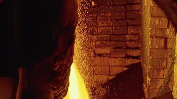 Molten raw materials in furnace. Stock footage. Close-up of bright molten substance pouring out in stream in industrial furnace video