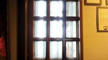 VIew inside of historical museum, glass window with wooden partitions and ancient documents hanging on the wall in frames. Stock footage. Reconstruction of historical events and places at the museum. video