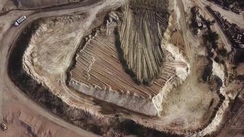 Aerial view of gravel quarry with many machine traces. Stock footage. Top view of industrial landscape after stone mining, construction industry. video
