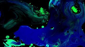 Fluid art background with colorful tints liquid surface. Stock footage. Amazing effect of acrylic paints on black canvas, mixing different bright colors. video