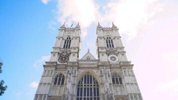 Facade of Gothic white building with towers on background of sky. Action. View from below of beautiful architecture of old Abbey building with Gothic style towers video