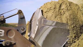 Close-up of excavator digging up ground. Stock footage. Digging operations using excavator to clear space for construction video