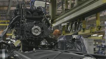 Russia - Moscow 15 March 2020. View inside of the car assembling plant and workers at the production line. Scene. Industrial workshop and assembly line for the production of commecical and military video