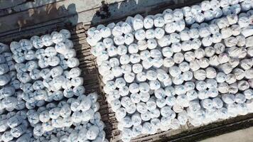 Top view of an open air warehouse with packed materials at the industrial city zone. Stock footage. Aerial view of many rows of packed insulation materials. video