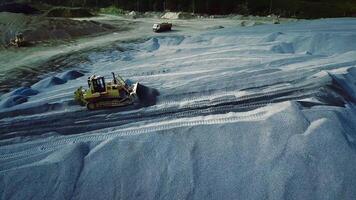 Large quarry and work of heavy mining machinery and equipment. Stock footage. Aerial view of a working excavator in sand career, industrial background. video