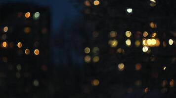 Glowing apartment building windows at night. Concept. Outdoor view of living house facade with warm illumination light, defocused lights becoming glowing windows. video