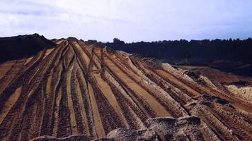 oben Aussicht von Sand Steinbruch, Bergbau von natürlich Ressourcen oder Erz, schwer Industrie Konzept. Lager Filmaufnahme. Antenne von das Steinbruch mit viele Rad Spuren. video