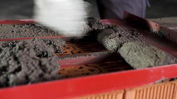 Bricklayer putting down raw cement and making an even layer to put another brick on it. Stock footage. Close up of making a brick wall process. video