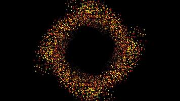 små partiklar av röd och gul färger rotera på en svart bakgrund formning en cirkel. animation. trogen modern dynamisk bakgrund med ljus partiklar. video