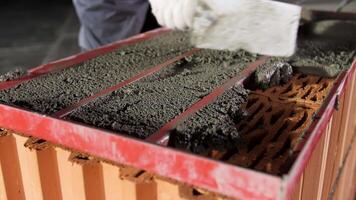 Close up of a bricklayer on a construction site with a trowel. Stock footage. Industrial worker using trowel for building exterior walls with bricks and mortar. video