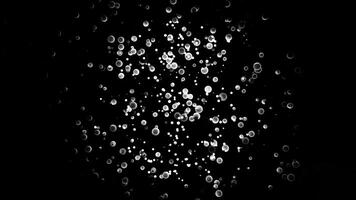 Abstract monochrome cloud swaying on black background surrounded by smaller particles, seamless loop. Animation. Silver small spheres and space dust in motion. video