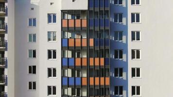 Close-up view facade of the beautiful colorful of a tall residential building. Motion. High-rise buildings modern architecture skyline. video