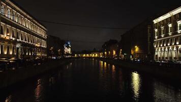 hermosa ver en el Santo San Petersburgo canal a noche Entre iluminado edificios y Moviente carros. concepto. pintoresco paisaje de el noche ciudad video