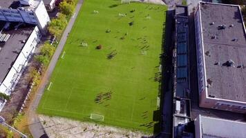 Football players running around the football field. Top view of the football youth tournament video