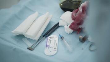 Surgical instruments and bloody bandages. Action. Close-up of surgical table with instruments and bloody bandages used during operation video