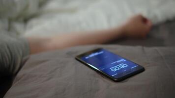 Mens is typen Aan smartphone terwijl aan het liegen in bed. concept. jong Mens kan niet slaap terwijl aan het wachten voor bericht van geliefde. leerling in liefde reageert naar bericht terwijl aan het liegen in bed video