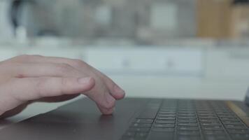 Close-up of man clicking on keyboard mouse of laptop. Action. Men's fingers move along touch panel of keyboard mouse on modern laptop video