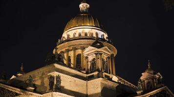 Beautiful architecture of Cathedral with dome and lighting in night. Action. Dome of Cathedral is illuminated with illumination at night. Illuminated Cathedral on background of night sky video