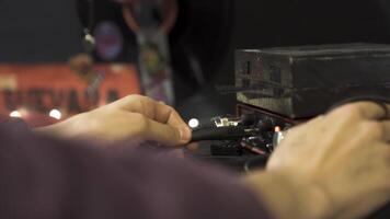 Side view of a hand inserting a wire into the switch. Stock footage. Close up of sound setting process, male hands adjusting the controls of the professional equipment. video