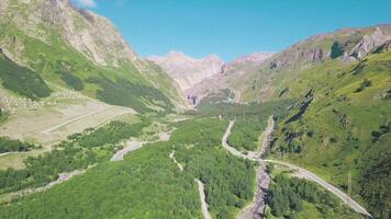 Top view of mountain green landscape with rocks on background of blue sky. Clip. Mountain gorge with green trees and sharp rocks looks spectacular. Summer mountain landscape video