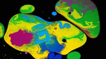 Fluid art background with colorful tints, liquid surface. Stock footage. Amazing effect of acrylic paints on black canvas, mixing different bright colors. video