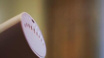 Close up of small manual steamer for ironing clothes. Concept. Steam coming from home use electric brush on blurred background of a room. video