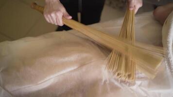 Massage with bamboo sticks. Action. Massage with bamboo brooms for cellulite. Bamboo sticks to help with wrapping and the most effective drainage massage. Spa treatments with massage video