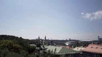 Beautiful cityscape of Moscow on blue sky background. Action. View of golden dome of a church and Luzhniki stadium on a sunny summer day. video