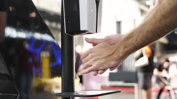 Close up of washing hands with an automatic alcohol sanitizer dispenser. Media. Hand sprayed by contactless auto sanitizer dispenser device, personal protection during coronavirus pandemic. video