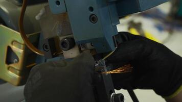 Close up of worker hands making a wire with a special machine. Creative. Industrial background at a factory workshop. video