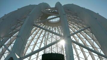 Dome construction of building. Stock footage. Beautiful frame construction of white dome on building. Modern architecture of building with through dome frame on background sky video