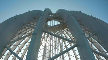 Dome construction of building. Stock footage. Beautiful frame construction of white dome on building. Modern architecture of building with through dome frame on background sky video