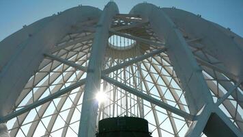 Dome construction of building. Stock footage. Beautiful frame construction of white dome on building. Modern architecture of building with through dome frame on background sky video