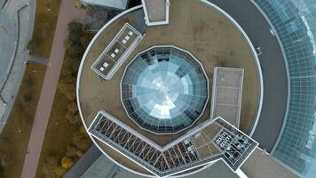 Top view of modern round building with dome. Stock footage. Beautiful architecture of business center with round structure and dome. Rings of building with beautiful facade video