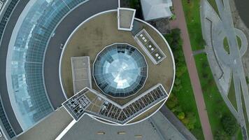 Top view of modern round building with dome. Stock footage. Beautiful architecture of business center with round structure and dome. Rings of building with beautiful facade video