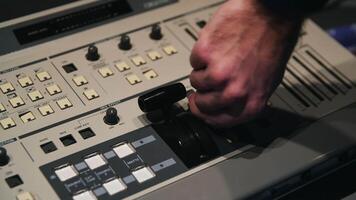 dichtbij omhoog van Mens accenten de toetsen Aan een machine controle paneel en schakelaars hen. media. mannetje arbeider hand- activeren mechanisme door schakelen tuimelaars. video