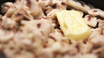 friterad kyckling kött, svamp och Smör i en fräsning panorera. begrepp. stänga upp av framställning kyckling filea med champignons och Smör smältande i en fräsning panorera. video