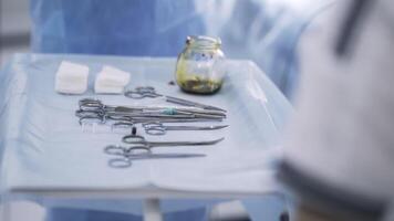 Close up of surgical table with instruments. Action. Medical sterile tools lying on a table with an iodine bowl, concept of medicine. video