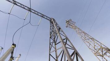 System of power equipment designed to transmit electricity through electric current. Action. Power line against the sky, bottom view. video